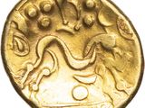 a close up of a gold coin on a white background