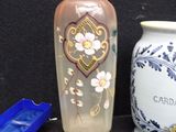 two vases sitting next to each other on a table