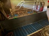 an image of a metal bed in a room with a fan