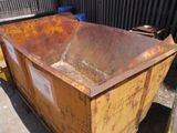 a large metal container sitting on the side of the road