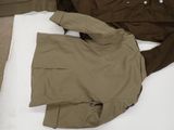 a jacket and pants laid out on a bed