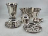 several pieces of silverware on a white table with a white background