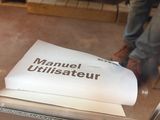 a man standing in front of a book on a table