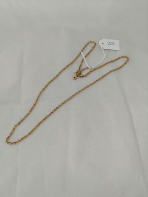 a gold chain with a heart charm on top of it
