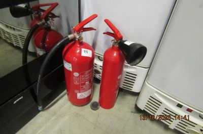 two fire extinguisors sitting next to each other on the floor