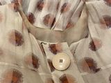 a picture of a dress with a button on it