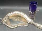 a silver spoon and a blue glass on a table