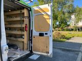 a white van that has a door open and shelves in the back