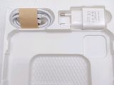 a white box with a charger and a cord attached to it