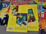 a lot of comic books on the table