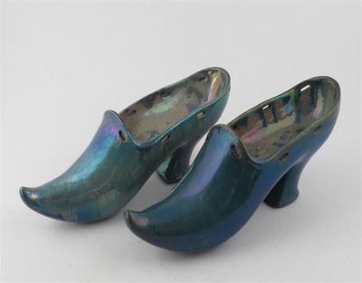 pair of blue and green clogs on a white surface