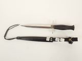 pair of black and silver knifes on a white surface