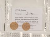 two coins sitting on top of each other in plastic bags