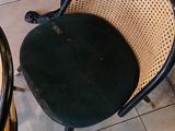 two chairs and a table in the corner of a room