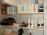many bottles and containers on the shelves in the kitchen