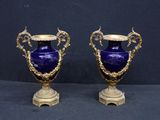 pair of antique blue vases with gold accents on pedestals