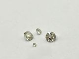 a group of three different sized diamonds on a white surface