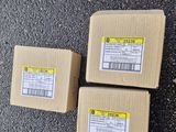 three boxes of food sitting on the ground next to each other