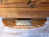 a wooden boat with a plaque on it on a table