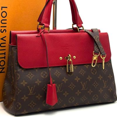 a louis vuitton handbag with a red and brown color