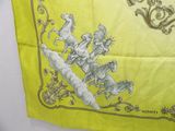 a yellow scarf with a picture of a man riding a horse