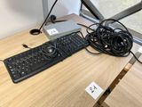 a keyboard and a mouse on a desk with wires