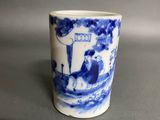 a blue and white cup with a picture of a boat on it