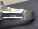 a close up of a watch on a black surface