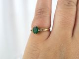 a close up of a person ' s hand with a ring on it