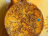 a yellow plate with a bird on it on a yellow tablecloth