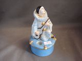 a figurine of a man sitting on top of a blue box