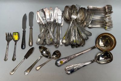 a lot of silverware on a table with spoons and forks
