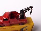 a red toy truck with a crane on top of it