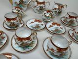many cups and saucers that are sitting on a table