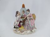 a figurine of a man and a woman sitting at a table