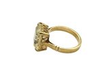 a close up of a gold ring with a stone in the middle
