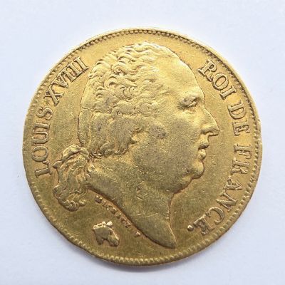 l'image d'une pièce d'or sur laquelle figure le visage d'une femme