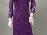 a mannequin wearing a purple lace dress with long sleeves
