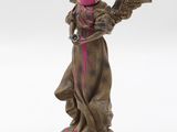statue of an angel with a hat on its head and wings on a base