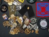 a lot of badges and other items on a table