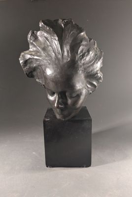 a close up of a sculpture of a woman ' s head on a black base