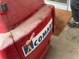 a man that is standing next to a red cooler