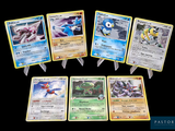 several pokemon cards are arranged in a row on a black background