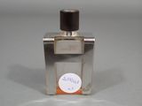 a bottle of perfume sitting on a table with a sticker on it