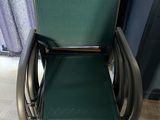 a green chair that is sitting in front of a window