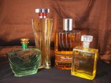 des flacons de différents parfums posés sur une surface noire