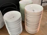 a lot of plates on a shelf in a room