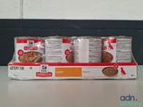 several cans of dog food sitting on top of a counter