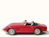 a red toy car with a man sitting in it