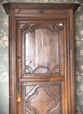 a wooden cabinet with a clock on top of it